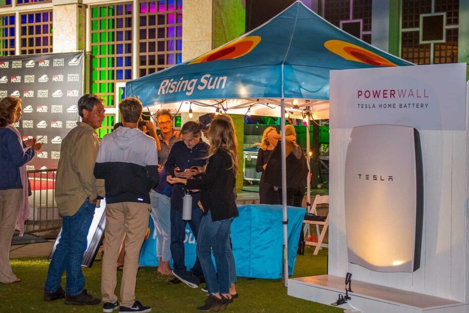 rising sun solar powerwall giveaway booth with people standing out front