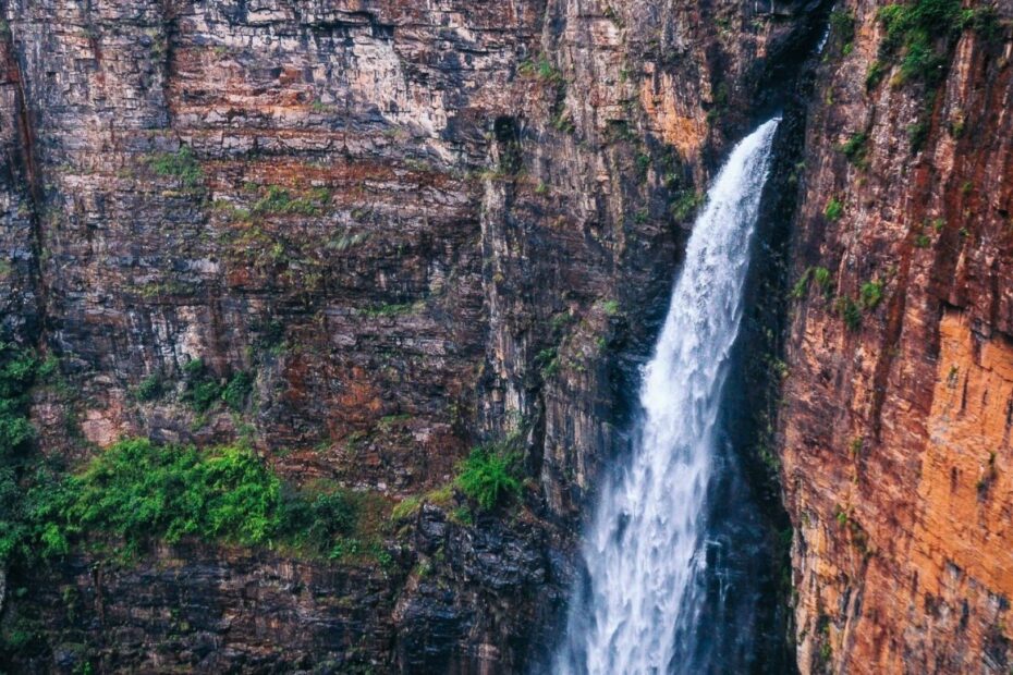 water fall with rocks and green foliage