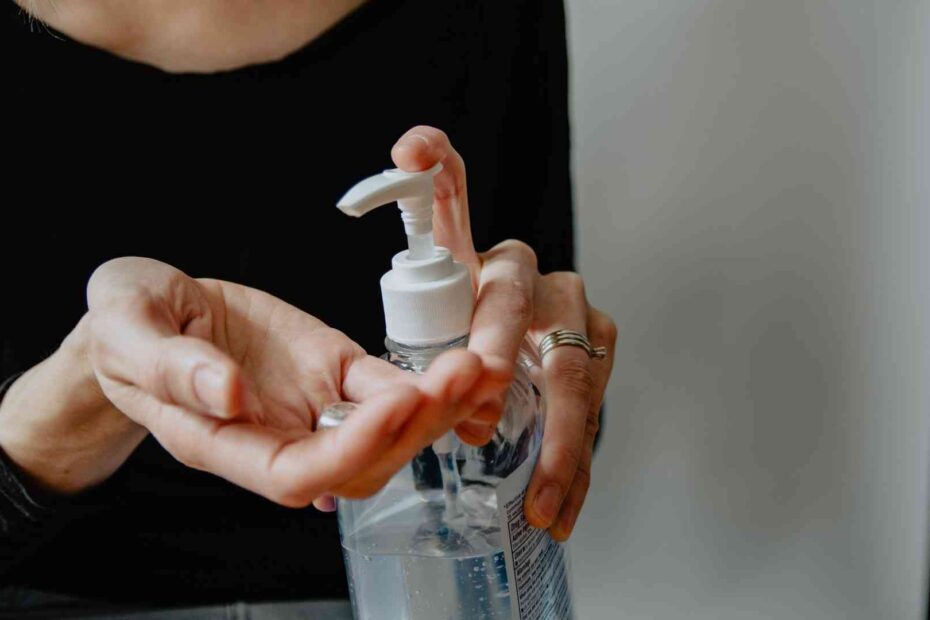 woman placing hand sanitizer in hand