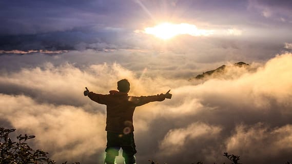 man at top of a mountain